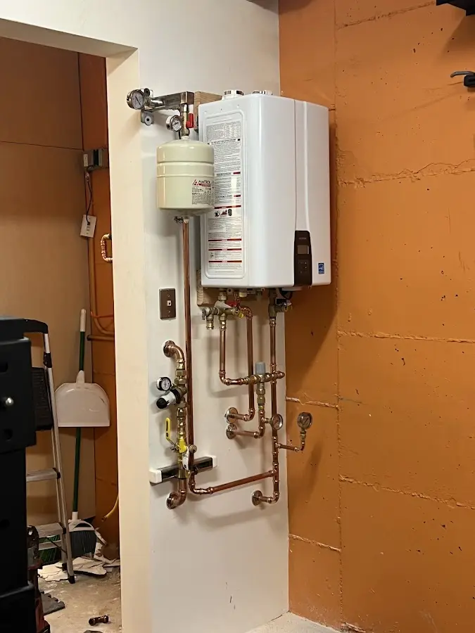 Plumbing technician inspecting water heater connections in Ukiah